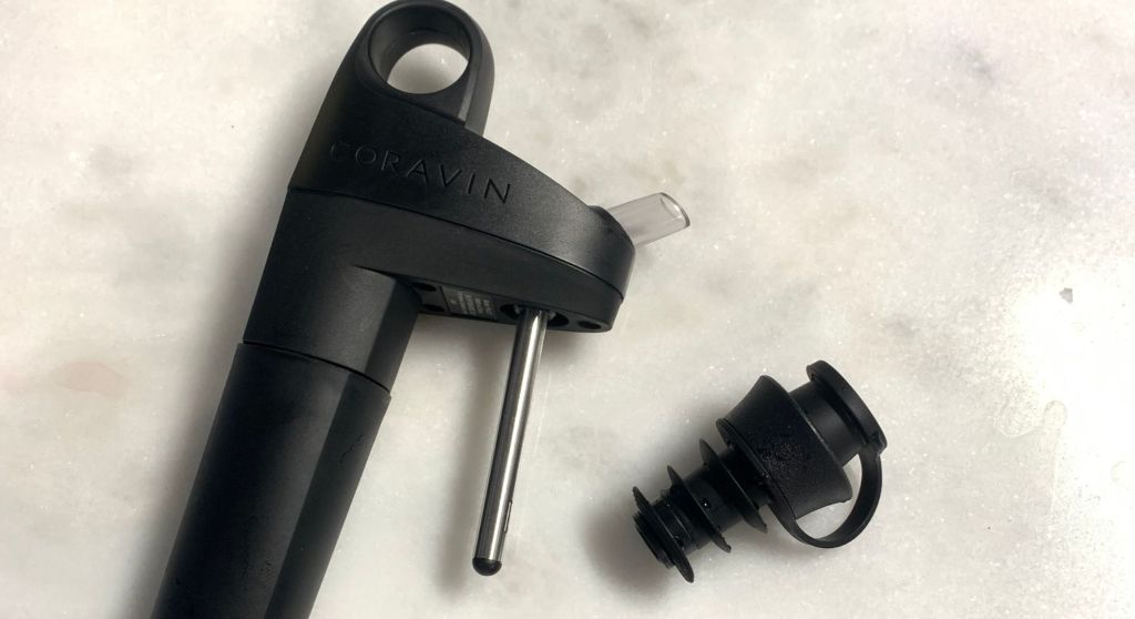 A closeup of the Coravin pivot wine preservation system, which includes a bottle stopper.